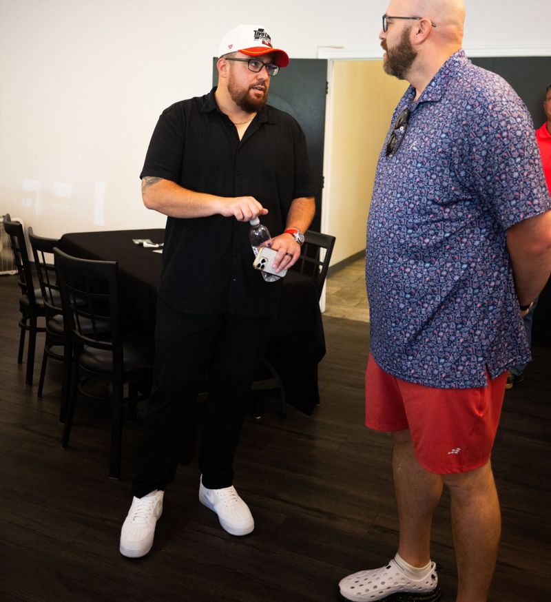 Luke Nesler in conversation with an attendee